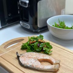A picture of Roasted salmon with green salad.