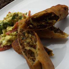 A picture of Chimichangas served with guacamole.