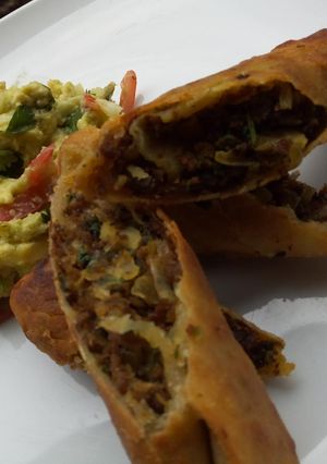 A picture of Chimichangas served with guacamole.