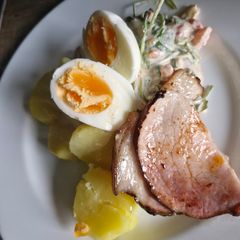 A picture of Grilled Pork with Boiled Potatoes and Salad.
