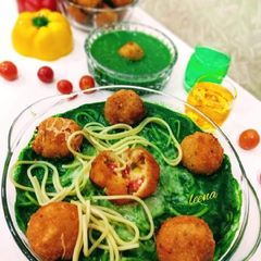 A picture of Risotto Balls with Spinach Sauce and baked Spaghetti.