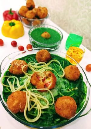 A picture of Risotto Balls with Spinach Sauce and baked Spaghetti.