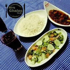 A picture of White rice with Mongolian chicken stew,Green salad and champman.