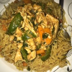 A picture of Egg fried rice and chicken sauce.