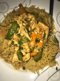 A picture of Egg fried rice and chicken sauce.