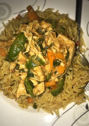 A picture of Egg fried rice and chicken sauce.