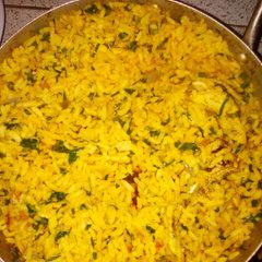 A picture of Palm oil rice with ugu leave.