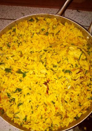 A picture of Palm oil rice with ugu leave.