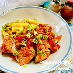 A picture of Mackerel in tomato sauce with vegetables.