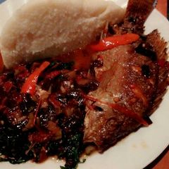 A picture of Wet fried tilapia with sukuma and ugali.