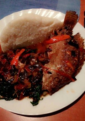 A picture of Wet fried tilapia with sukuma and ugali.