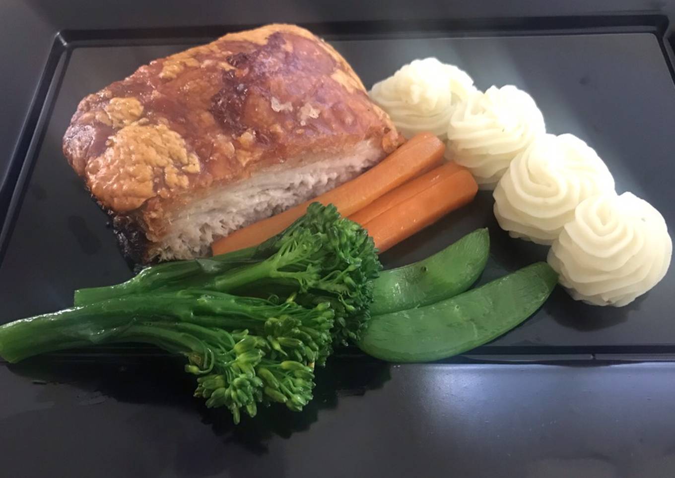 Slow roasted belly pork,with buttered vegetables and apple puréed mash potato