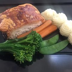 A picture of Slow roasted belly pork,with buttered vegetables and apple puréed mash potato.