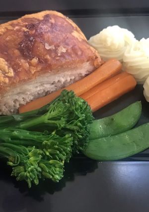 A picture of Slow roasted belly pork,with buttered vegetables and apple puréed mash potato.