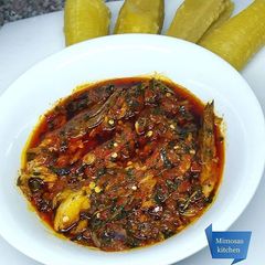 A picture of Boiled unripe plantains with nchianwu sauce.