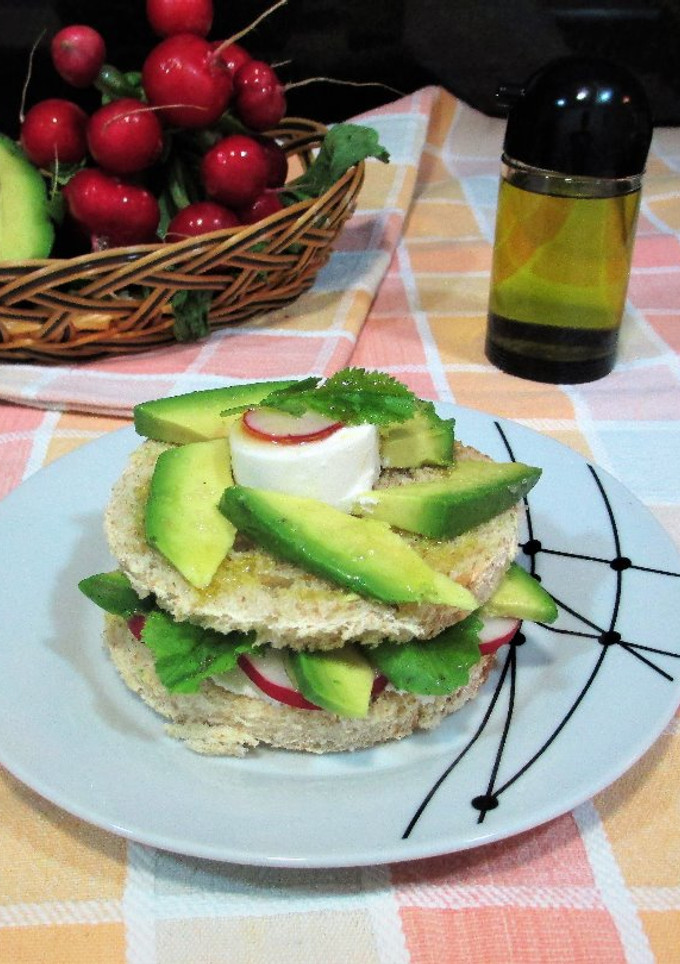 Una foto de Sándwich de pan de molde con aguacate, rábanos rosa y queso de cabra