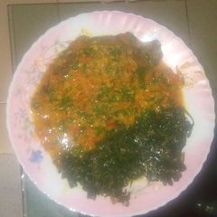 Fish in coconut sauce and a side of kunde A picture of Fish in coconut sauce and a side of kunde.