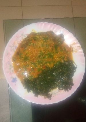 A picture of Fish in coconut sauce and a side of kunde.