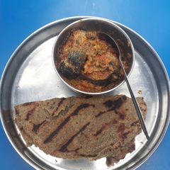 Fish in gravy with bajra roti A picture of Fish in gravy with bajra roti.