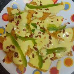 A picture of Doritos (nachos chips) in cheese sauce.