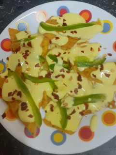 A picture of Doritos (nachos chips) in cheese sauce.