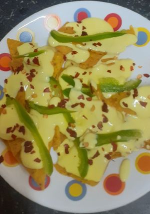 A picture of Doritos (nachos chips) in cheese sauce.