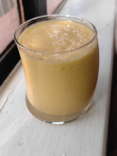 A picture of Pineapple and mango smoothie, with ice cream.