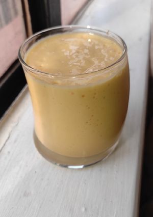A picture of Pineapple and mango smoothie, with ice cream.