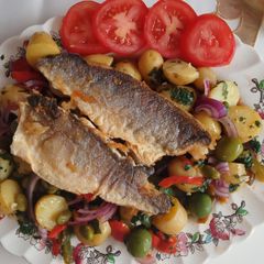 A picture of Pan fried sea bass fillets with mediterranean potato salad.