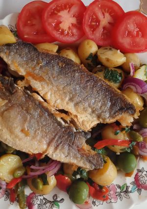 A picture of Pan fried sea bass fillets with mediterranean potato salad.