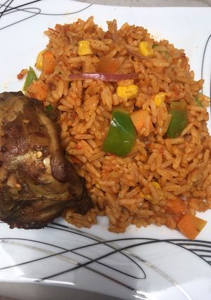 A picture of Jollof rice with grilled chicken.