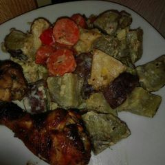 A picture of Grilled chicken with veggies.