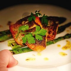Pan fried sea bass, chargrilled asparagus & lemon dill butter A picture of Pan fried sea bass, chargrilled asparagus & lemon dill butter.