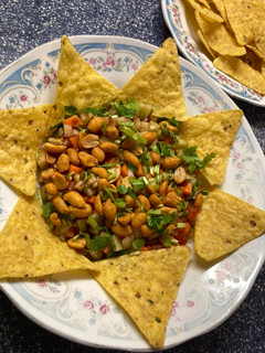 A picture of Nachos with salsa salad 🥗.