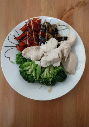 A picture of Poached chicken breast and roasted veggies bowl.