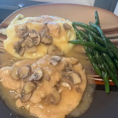 A picture of Chicken Marsala: with mashed potatoes and garlic green beans.