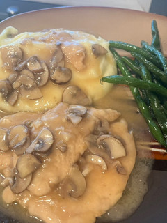 A picture of Chicken Marsala: with mashed potatoes and garlic green beans.