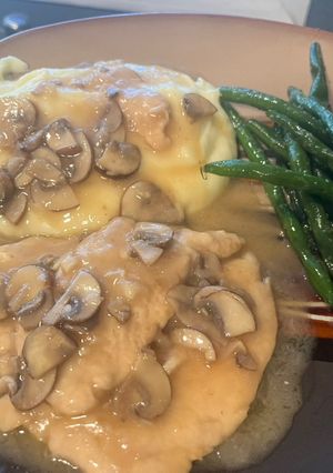 A picture of Chicken Marsala: with mashed potatoes and garlic green beans.