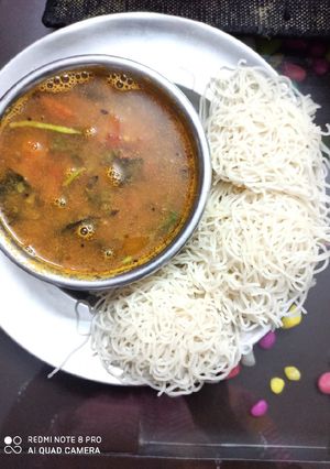 A picture of Idiyaapam with rasam.