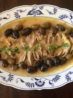 A picture of California Farm Duck with olives dinner.