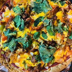 A picture of Pizza with spinach.