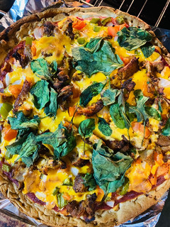 A picture of Pizza with spinach.