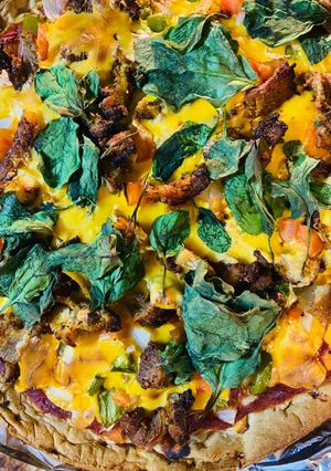 A picture of Pizza with spinach.