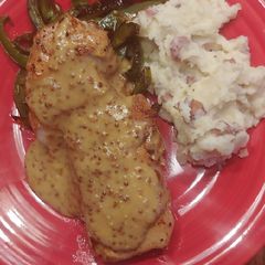 Pan seared pork chop with mustard sauce and green peppers A picture of Pan seared pork chop with mustard sauce and green peppers.