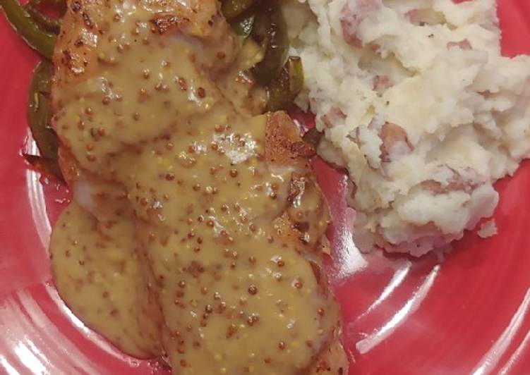 Pan seared pork chop with mustard sauce and green peppers