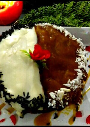 A picture of Mango cake topping with chocolate and mango sauce.