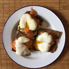 A picture of Perfect poached eggs with salmon & avocado on rye.
