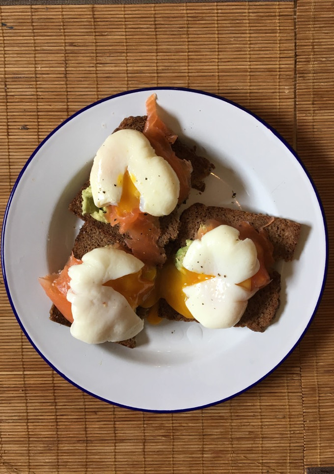 A picture of Perfect poached eggs with salmon & avocado on rye.