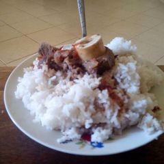 A picture of Rice with stew beef.