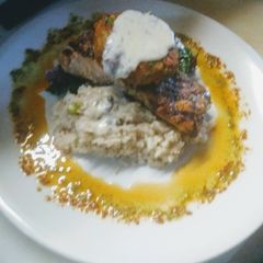 A picture of Grilled Salmon Parm Rice Swiss Chard w/Crab Cake and Dill Butter.